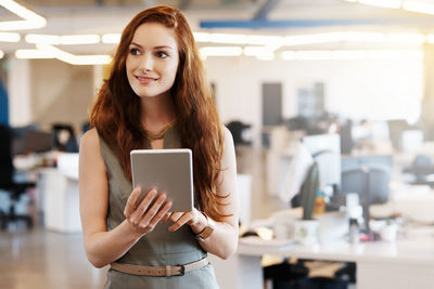 Portrait of young woman using mobile phone