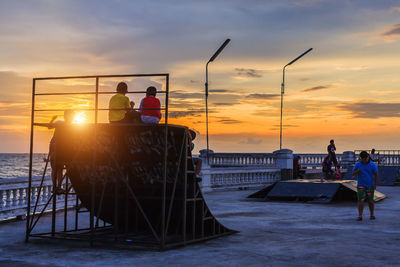 People at skateboard park during sunset