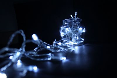 Close-up of wine glass on table against black background