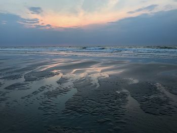 Scenic view of beach against sky during sunset