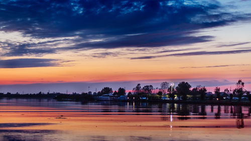 Scenic view of lake against orange sky