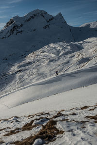 Person hiking on snowcapped mountain