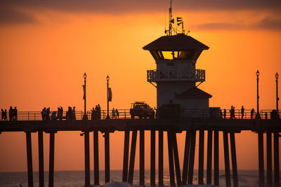 Silhouette of lighthouse against sky during sunset