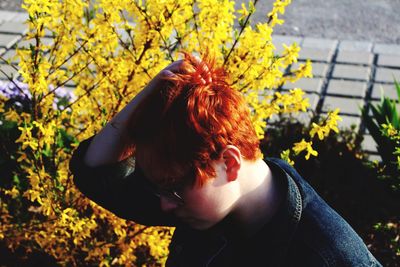 Close-up of girl with yellow flowers