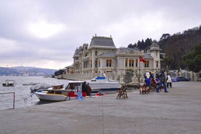 People in front of buildings against sky