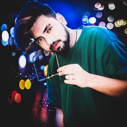 Portrait of young man holding camera