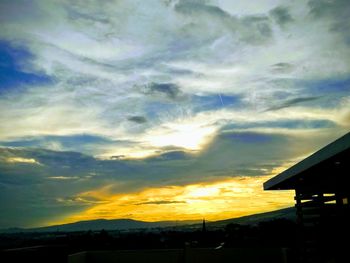 Silhouette buildings against sky during sunset