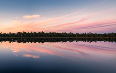 Scenic view of lake against romantic sky at sunset