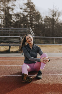 Woman sitting at running track