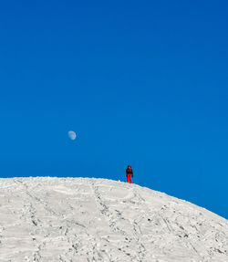 People skiing on snow covered landscape