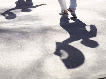 Low section of people standing on road