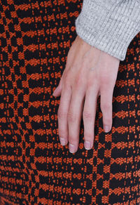 Cropped hand of woman on fabric