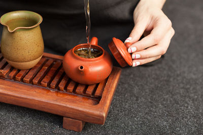 High angle view of woman hand on table