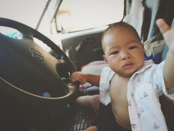 Portrait of cute boy in car