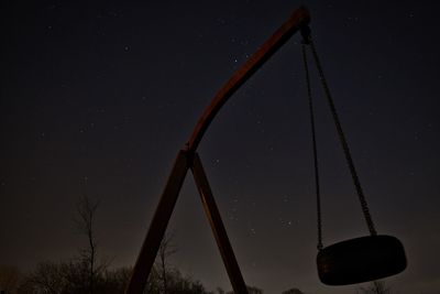 Low angle view of illuminated metallic structure against sky at night