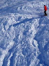 High angle view of person skiing downhill on snow