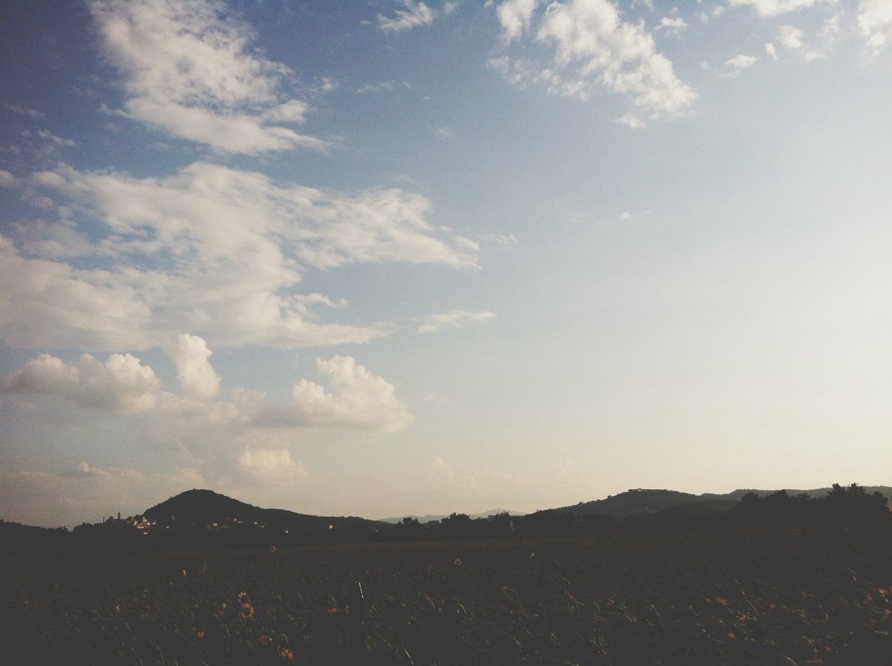 sky, tranquility, tranquil scene, scenics, beauty in nature, cloud - sky, nature, landscape, cloud, cloudy, low angle view, idyllic, outdoors, mountain, remote, no people, non-urban scene, blue, day, silhouette