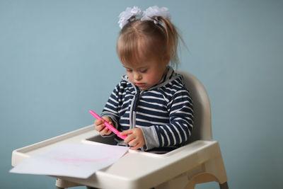 Boy writing in book at home