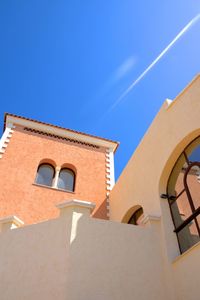 Low angle view of building against blue sky