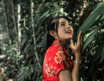 Portrait of a smiling young woman standing outdoors