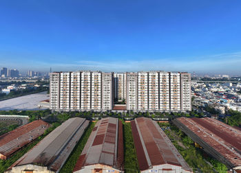 Buildings in city against blue sky