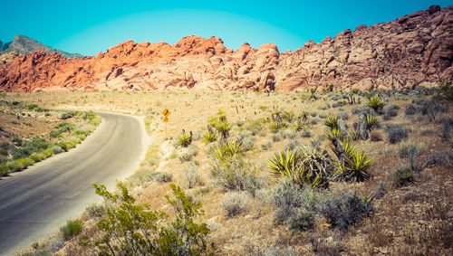 Empty road by rock formations