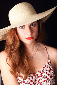 Portrait of beautiful young woman wearing hat