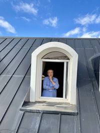 Low angle view of man standing against blue sky