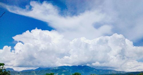 Scenic view of mountains against cloudy sky