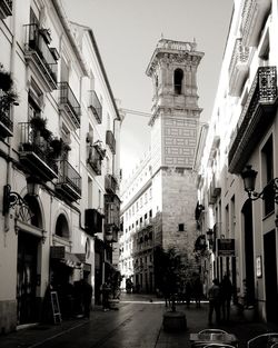 Street amidst buildings against sky in city