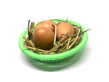 Close-up of eggs against white background