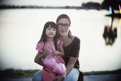 Portrait of a smiling girl with daughter in water