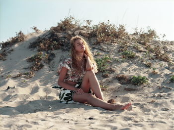 Portrait of young woman sitting on beach