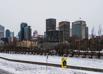 View of modern buildings in city against clear sky