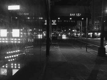 Illuminated city street at night