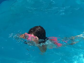 Portrait of boy swimming in pool