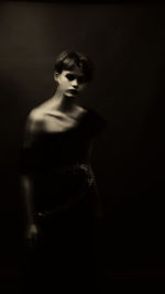 Portrait of a beautiful young woman over black background