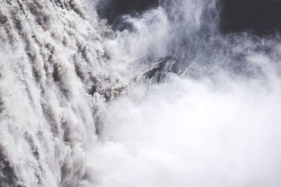 Low angle view of waterfall against sky