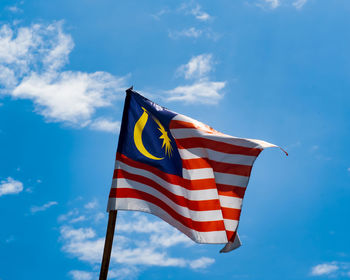 Malaysia flag waving against blue skies.