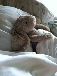 Close-up of stuffed toy lying in bed