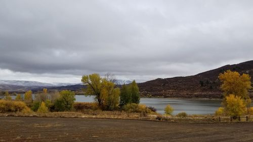 Scenic view of lake and mountains against sky