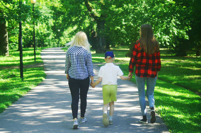 Rear view of women walking in park