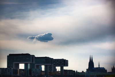 View of cityscape against cloudy sky