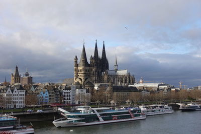 Boats in river with buildings in background