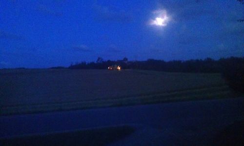 Scenic view of agricultural landscape against sky at night