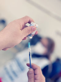 Close-up of hand holding cigarette