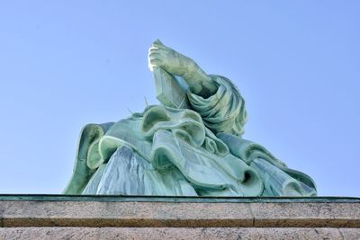 Low angle view of statue against clear blue sky