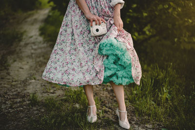 Low section of women standing on field