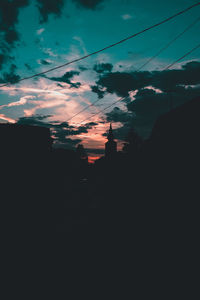 Silhouette landscape against sky at sunset