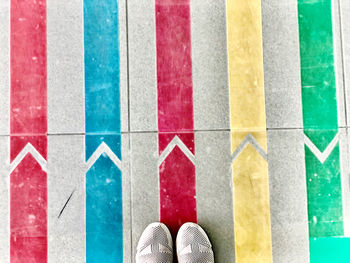 Low section of person standing on tiled floor